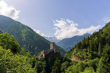 Fototapeta na wymiar Landscape of Zilkale castle, forest, and cloudy mountains. Castle located in Camlihemsin, Rize, Black Sea region of Turkey