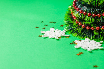 Christmas decoration on the green background. Ornaments, snowflakes, stars. Christmas tree.