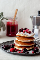 Pancakes with blackberries, raspberries and red currants. American cuisine.