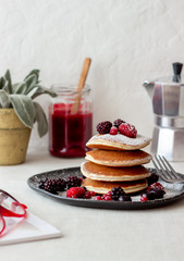 Pancakes with blackberries, raspberries and red currants. American cuisine.