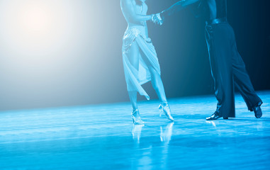 woman and man dancer latino international dancing. Blue filter