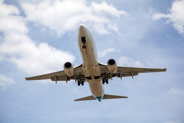 Fototapeta na wymiar Close up of passenger plane landing overhead