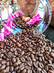  lots of healthy and fresh coffee beans those are fall out of a Crystal jar that was kept on the table 