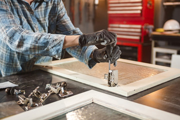 Carpenter working on the old wood in a retro vintage workshop.