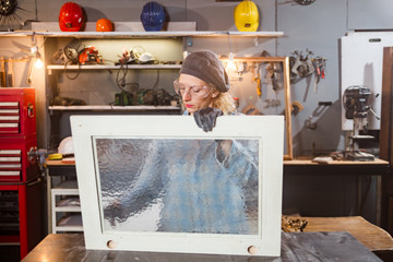 Carpenter working on the old wood in a retro vintage workshop.