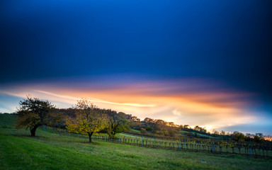 Fototapeta na wymiar sunset and dramatic clouds on a hill called goldberg in burgenland