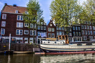 Fototapeta na wymiar Typical buildings, canal and bikes in Amsterdam, Netherlands