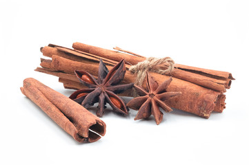Close-up of Cinnamon sticks heap and star anise spice isolated on  white background.