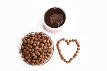 corn brown balls in a glass plate and a heart-shaped pattern for valentines day