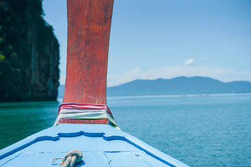 Closeup wooden plate on the boat head tied by colourful clothes for luckiness