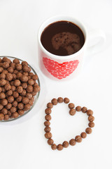 corn brown balls in a glass plate and a heart-shaped pattern for valentines day