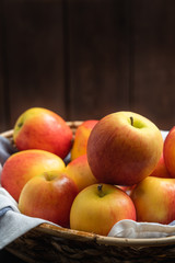 Fototapeta na wymiar Fresh apple in basket with rustic wood background