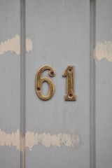 number 61 on white door