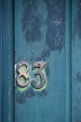 number 83 on green door
