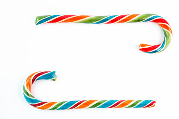 Two colorful festive Lollipop in form of frame on white background selective focus top of view