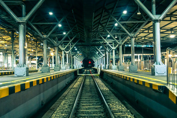 Obraz premium Railway station at night, Railroad tracks, Train
