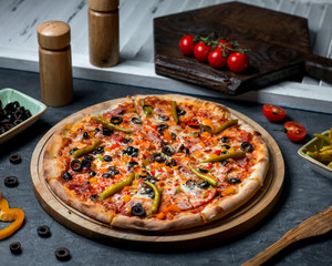 spicy pizza topped with pepper and olives