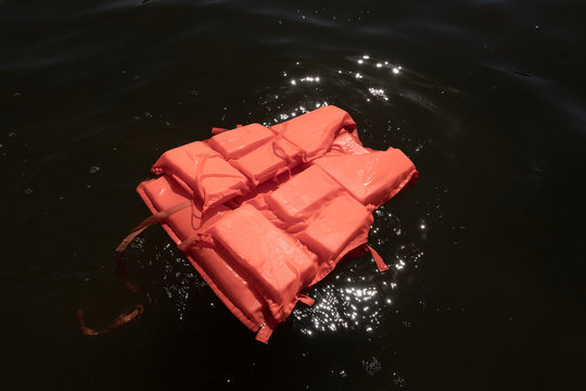 Orange Life Jacket In Sea Water.