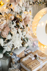 Close up a Christmas tree lights glittering at night. New Year fir tree with decorations and illumination. Xmas tree decorations background. Many large golden balls on fir tree New Year and Christmas