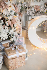 Close up a Christmas tree lights glittering at night. New Year fir tree with decorations and illumination. Xmas tree decorations background. Many large golden balls on fir tree New Year and Christmas