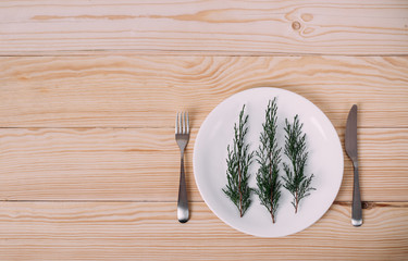 Merry christmas and a happy new year! Christmas tree on a white plate. Black background, copy space. For menu and restaurants for the holidays.