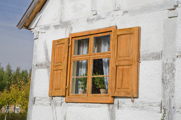 antique window in a wooden house in the open-air museum of the Polish countryside