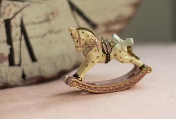 Christmas decoration, rocking horse on a pink background.