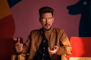 young man throws up bitcoins. bitcoins instead of eyes. Greed, emotions, black cash.