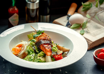 mixed salad topped with fried salmon