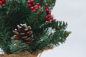 Merry christmas and a happy new year! Green Christmas tree lightly dusted with snow. Plastic...