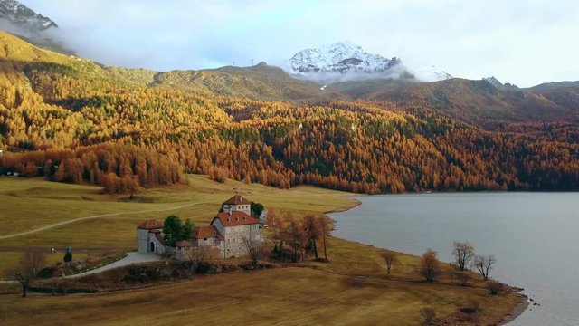 Amazing autumn forest in mountains, castle on lake