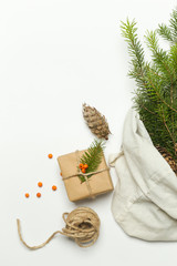 Zero waste wrapping gifts concept. Natural Christmas decoration, pine cones and fir branches in cotton bag.