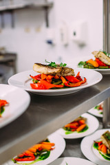 Cooking a delicious main course in the restaurant kitchen. Catering on holiday.