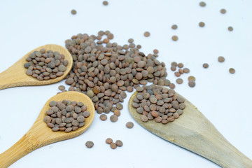 Lentils with white background and wooden spoon