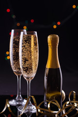 Two Glasses of Champagne against Blurred Christmas Lights. Shallow Depth of Field.