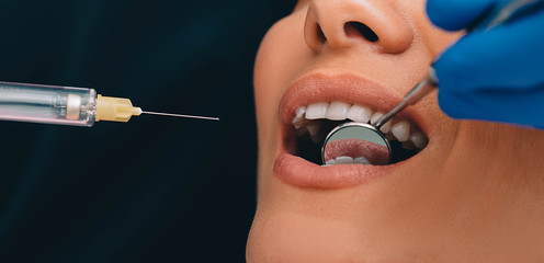 procedure teeth anesthesia ,macro. Teeth treatment without pain.Syringe with anesthesia near teeth