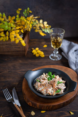 Fried Chanterelles with onions, sauce and fresh herbs on the plate. ketogenic diet. Restaurant menu