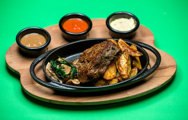 steak with side mushrooms and fried potato