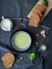 green cream broccoli soup with rye bread. 
