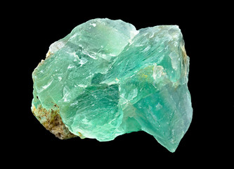 Green translucent fluorite rough mineral stone on a black background