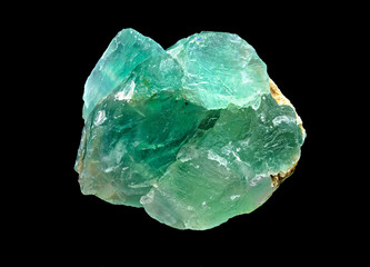 Green translucent fluorite rough mineral stone on a black background