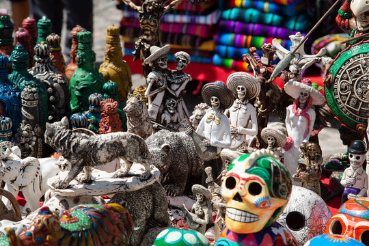 Dancing skull ceramics- colorful painted skull crafts in the market - Día de Muertos - Mexico