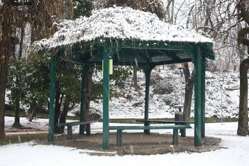 winter scene in a park: a gazebo covered of snow