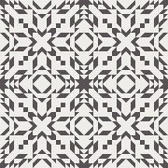 Seamless kilim repeat vector pattern swatch. Aztec, ethnic, african, tribal, or navajo design. Triangles, rhombuses, and other shapes cut from a grid. Chic contemporary geometric motif.