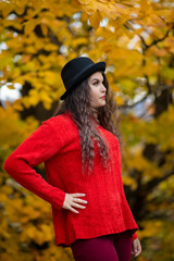 Portrait of a beautiful hispanic young woman in an autumnal forest