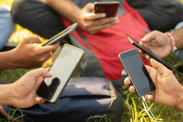 Close up of young people hands holding mobile - College Students addicted to smartphone - young millennials busy on cell phone - Group of friends sharing content on social media.