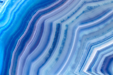 Close up details on a blue polished agate specimen slice isolated on white limbo background