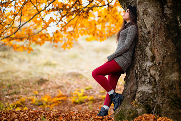 Portrait of a beautiful hispanic young woman in an autumnal forest