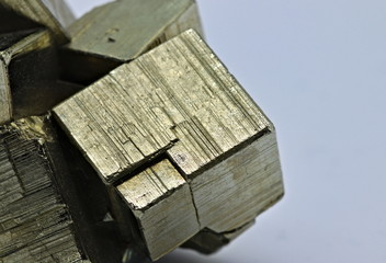 Close up detail on a cube of pyrite isolated single shiny mineral stone, fool's gold, cubic gems,...