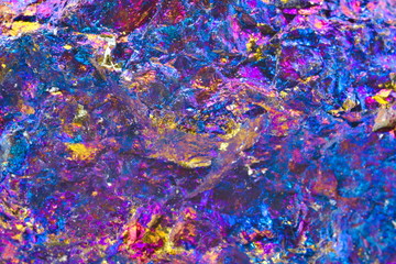 Close up details on the surface of a chalcopyrite blue multi colored stone mineral gem
